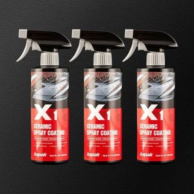 Three Kapak X1 ceramic spray coating bottles on dark background