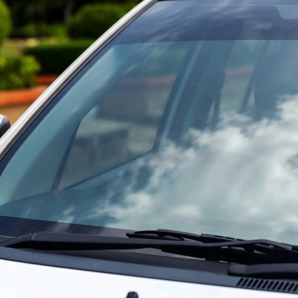 Clean car windshield with clear streak free glass after removing bugs and road grime